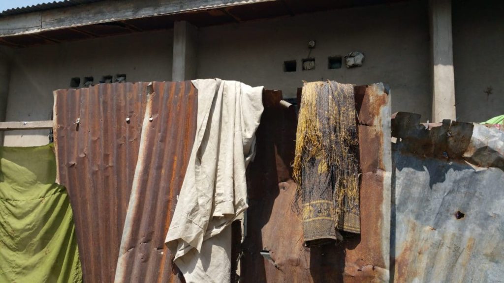 Metal sheeting surrounding a house without roof, North East of Nigeria