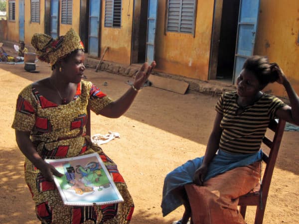 Madeleine, 35, advising a women during a home visit, Benin